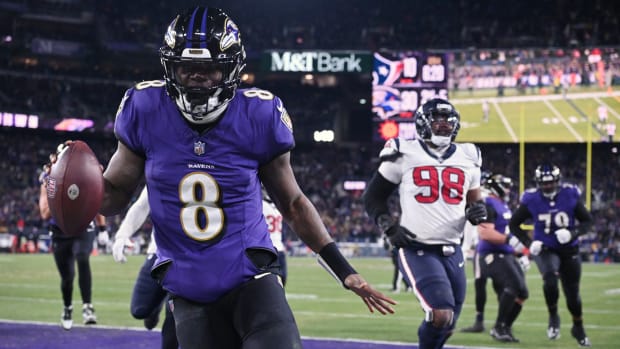 Lamar Jackson runs with the ball